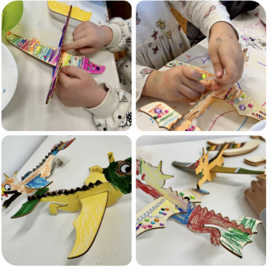 Hände von Kindern basteln und bemalen Papierdrachen in bunten Farben.