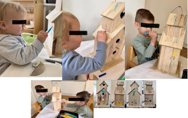 Zwei Kinder malen Holzmodelle, eine kreative Beschäftigung am Tisch.