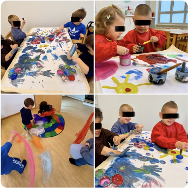 Kinder malen und spielen mit Farben, Pinsel und Tüchern in einem hellen Raum.